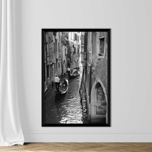 Venice, gondolas in canal amid buildings (B&W)