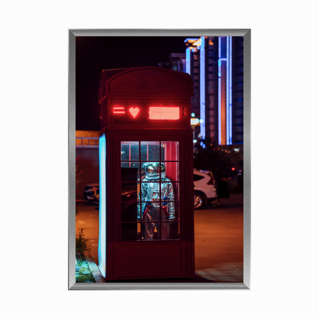 Spaceman standing in a telephone box at night