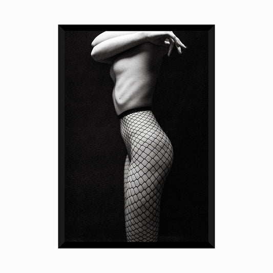 Black and white photo of womans legs in fishnet tights